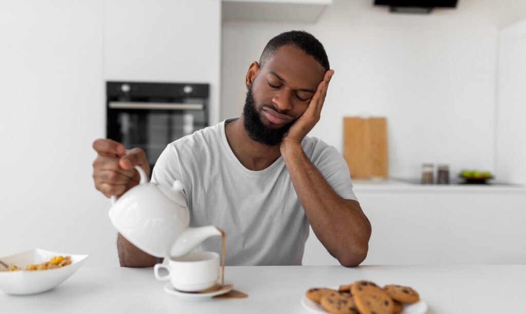 tired man eating breakfast